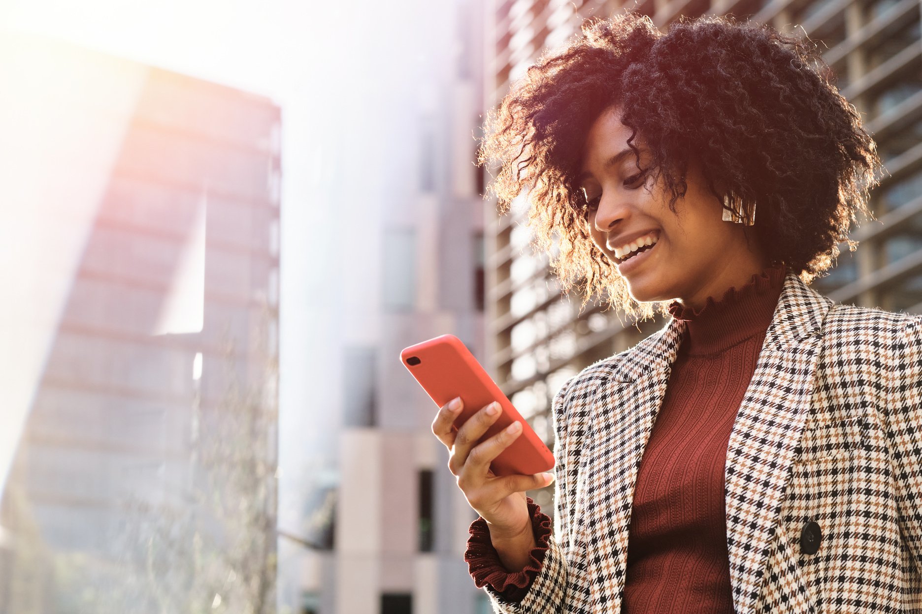 Businesswoman Smiling While Using Mobile Phone